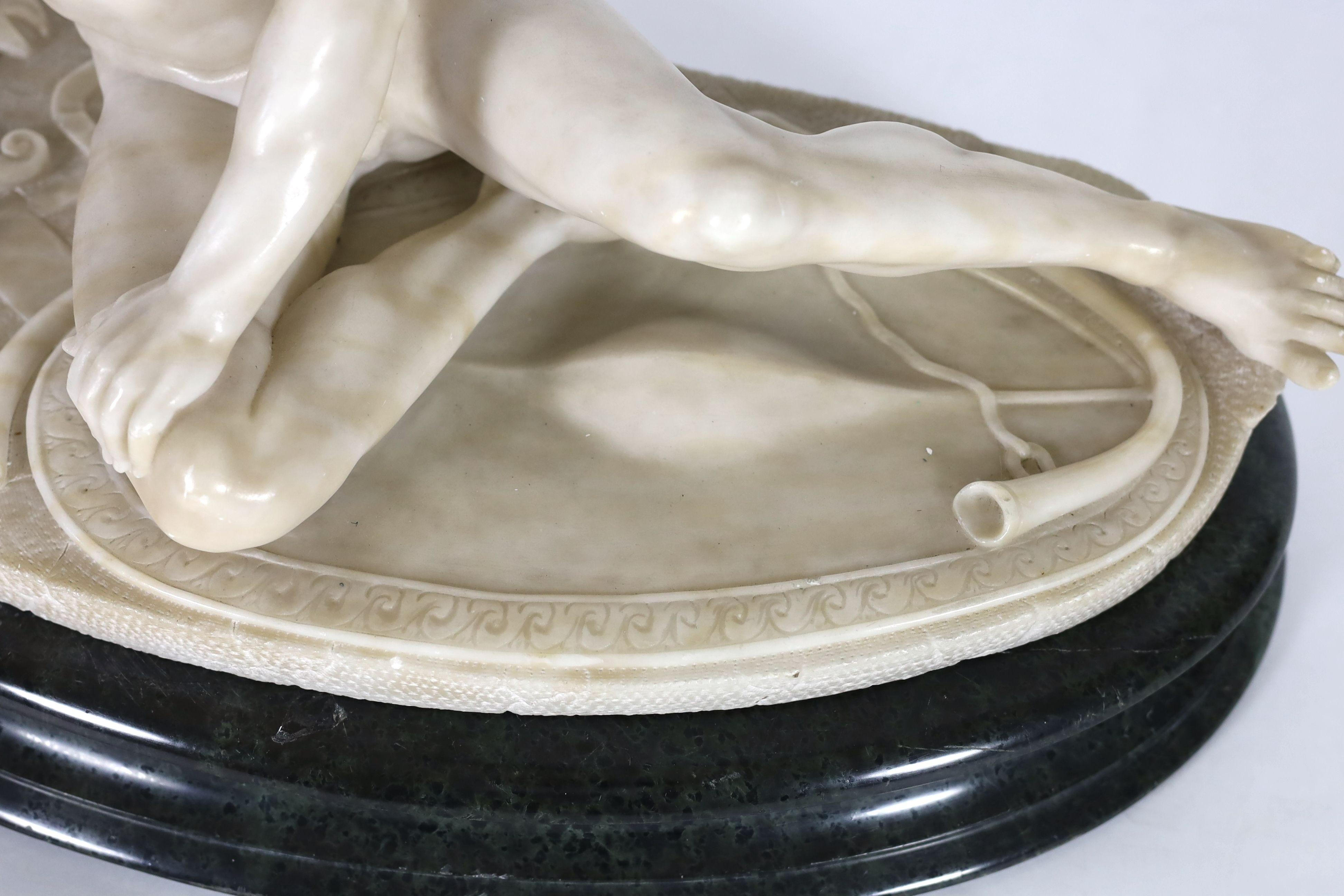 A late 19th century carved alabaster model of The Dying Gaul, width 65cm, height 43cm